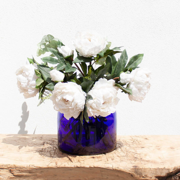 Blue glass vase with flowers